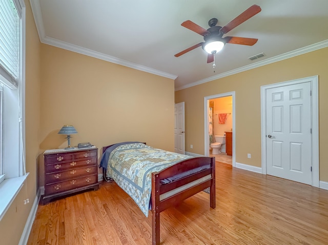 bedroom featuring baseboards, visible vents, ornamental molding, and light wood-style flooring