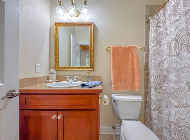 bathroom with vanity, curtained shower, and toilet