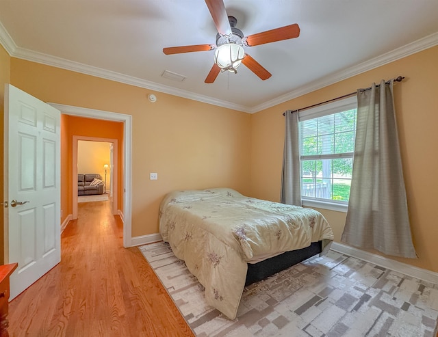 bedroom featuring crown molding, baseboards, visible vents, and light wood finished floors