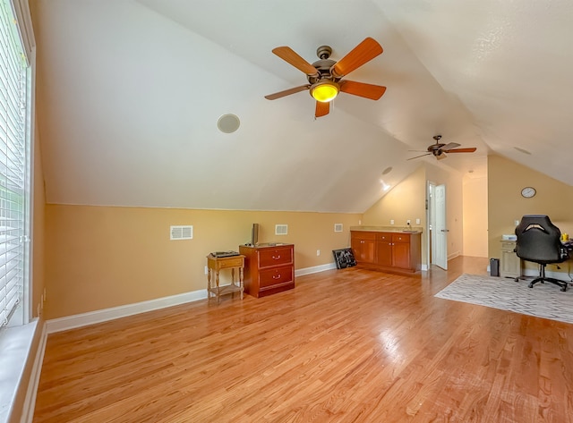 unfurnished office featuring ceiling fan, visible vents, light wood finished floors, and lofted ceiling