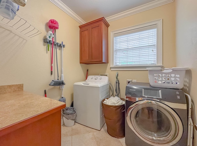 clothes washing area featuring cabinet space, independent washer and dryer, crown molding, and light tile patterned flooring