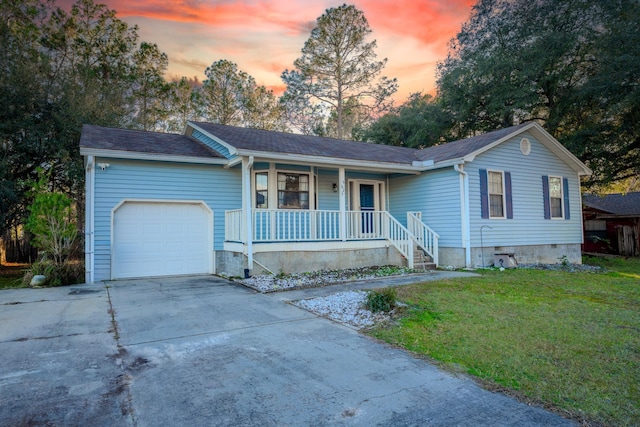 single story home with a lawn, a porch, and a garage