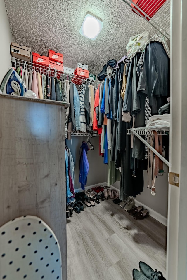 walk in closet featuring hardwood / wood-style flooring