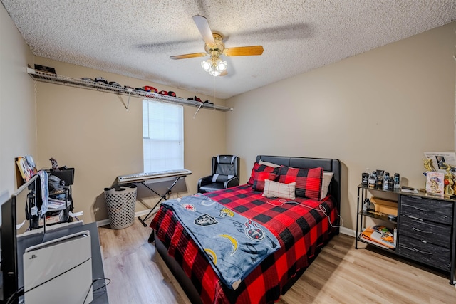 bedroom featuring ceiling fan, a textured ceiling, and hardwood / wood-style flooring