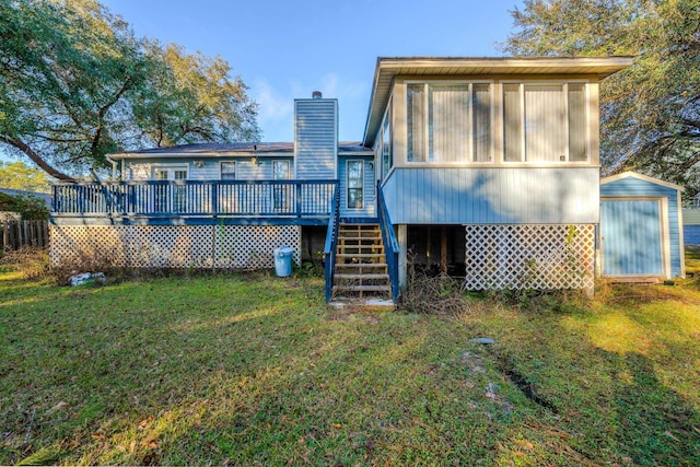 rear view of property featuring a deck and a lawn