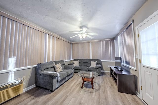 living room with ceiling fan, radiator, and light hardwood / wood-style floors