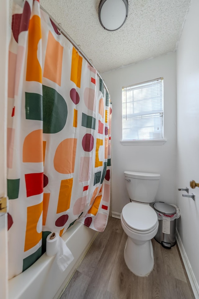 bathroom featuring wood-type flooring, toilet, and shower / tub combo