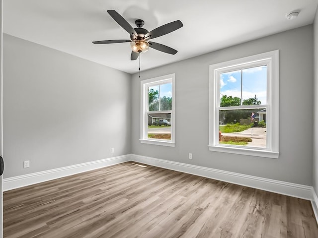 empty room with light wood-type flooring and ceiling fan