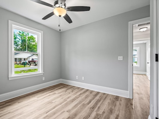 spare room featuring light wood-type flooring and ceiling fan