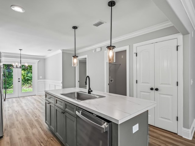 kitchen with sink, dishwasher, gray cabinets, hanging light fixtures, and an island with sink