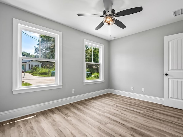 spare room featuring ceiling fan, plenty of natural light, and light hardwood / wood-style floors