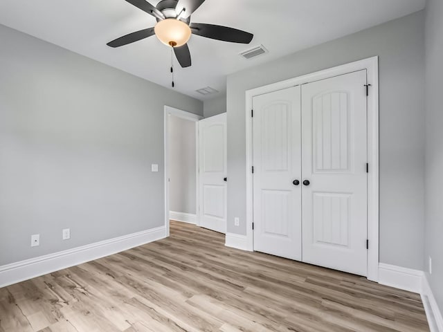 unfurnished bedroom with ceiling fan, a closet, and light hardwood / wood-style floors