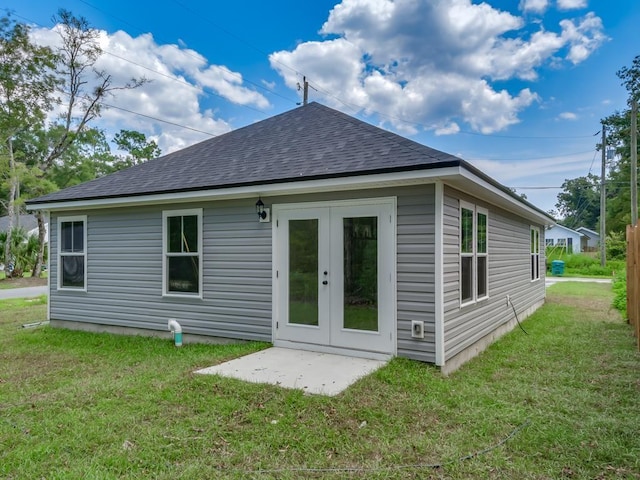 back of property with french doors, a yard, and a patio