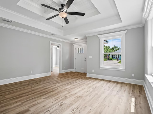 interior space featuring light hardwood / wood-style floors, a raised ceiling, ceiling fan, and ornamental molding