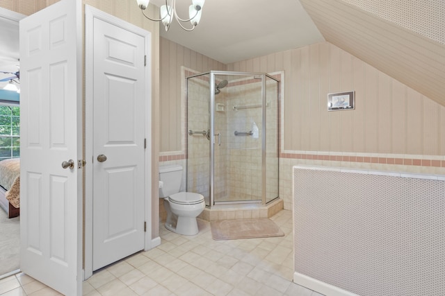 1961 Chatsworth Way, Tallahassee, FL 32309 - bathroom with lofted ceiling, a shower stall, a chandelier, tile patterned floors, and wainscoting