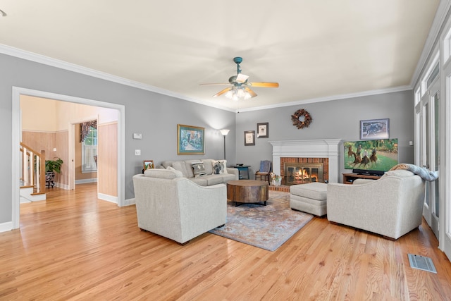 1961 Chatsworth Way, Tallahassee, FL 32309 - living room with a ceiling fan, light wood-style floors, stairway, a brick fireplace, and crown molding