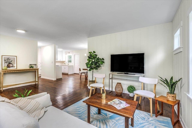 living room with baseboards and wood finished floors