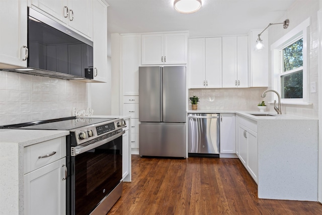 kitchen with stainless steel appliances, dark wood-type flooring, a sink, and white cabinetry