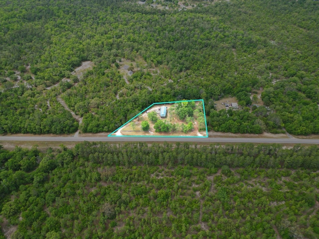 birds eye view of property featuring a view of trees