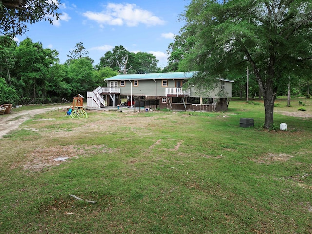 view of yard featuring a wooden deck and stairway