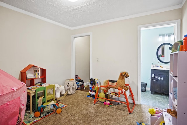 game room featuring carpet floors, ornamental molding, and a textured ceiling