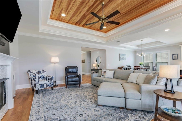 3837 Broadmore Ln, Tallahassee, FL 32308 - living room with a raised ceiling, ceiling fan, a premium fireplace, ornamental molding, and wood finished floors