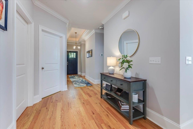 3837 Broadmore Ln, Tallahassee, FL 32308 - hall with light wood-style floors, a chandelier, ornamental molding, and baseboards