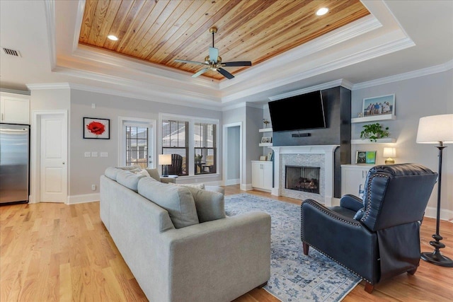 3837 Broadmore Ln, Tallahassee, FL 32308 - living area with a raised ceiling, a ceiling fan, crown molding, baseboards, and light wood-type flooring
