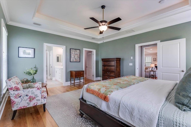 3837 Broadmore Ln, Tallahassee, FL 32308 - bedroom featuring a raised ceiling, wood finished floors, ornamental molding, baseboards, and ensuite bath