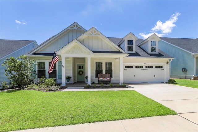 3837 Broadmore Ln, Tallahassee, FL 32308 - view of front of property with a garage, board and batten siding, concrete driveway, and a front yard