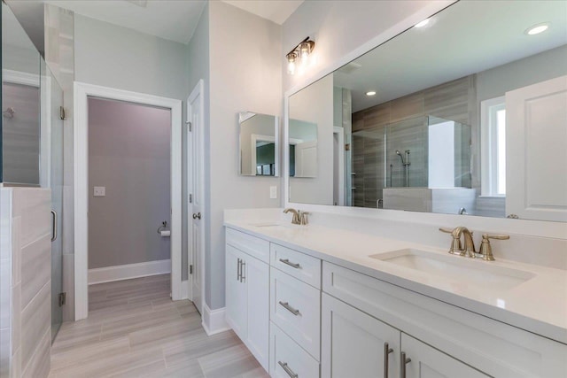 3837 Broadmore Ln, Tallahassee, FL 32308 - bathroom with a shower stall, double vanity, baseboards, and recessed lighting