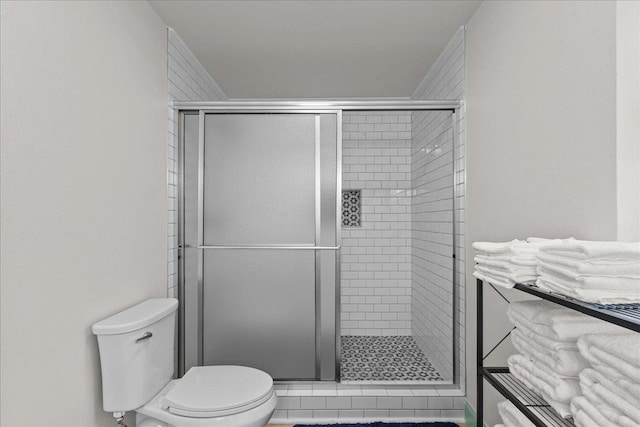 bathroom featuring toilet and walk in shower