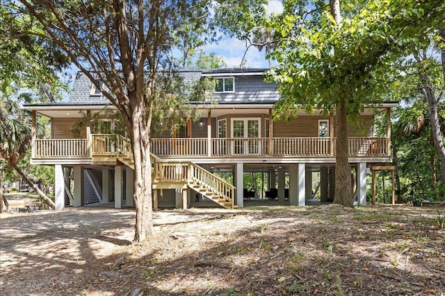 rear view of property with a carport and covered porch