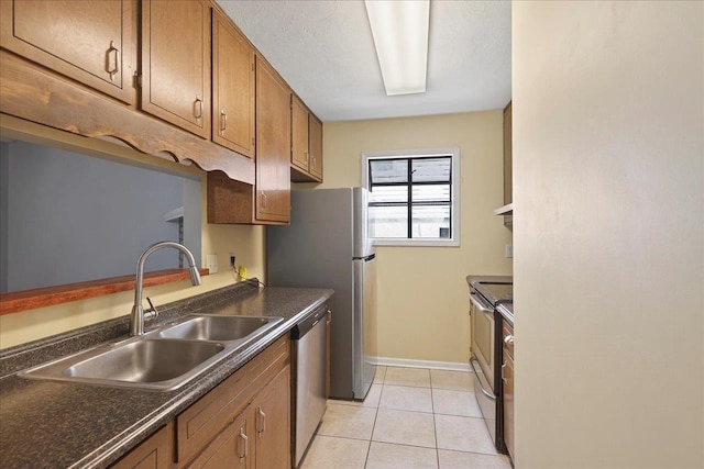 1515 Merry Oaks Ct, Tallahassee, FL 32303 - kitchen featuring appliances with stainless steel finishes, dark countertops, brown cabinetry, under cabinet range hood, and light tile patterned flooring