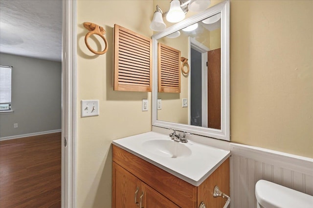 1515 Merry Oaks Ct, Tallahassee, FL 32303 - bathroom featuring vanity, a wainscoted wall, and wood finished floors