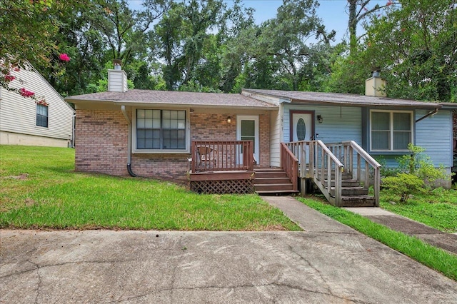 1515 Merry Oaks Ct, Tallahassee, FL 32303 - view of front of house with a chimney, a front yard, brick siding, and a porch