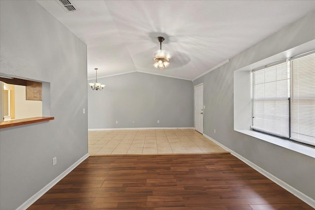 1515 Merry Oaks Ct, Tallahassee, FL 32303 - unfurnished room with a chandelier, wood finished floors, lofted ceiling, and a ceiling fan