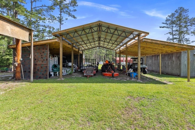 view of parking / parking lot with a carport and an outbuilding