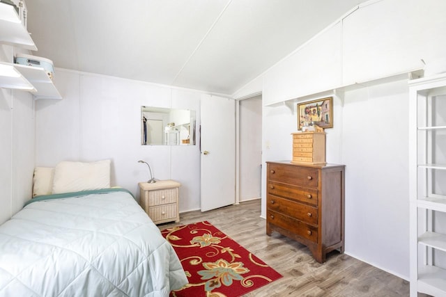 bedroom featuring lofted ceiling and wood finished floors