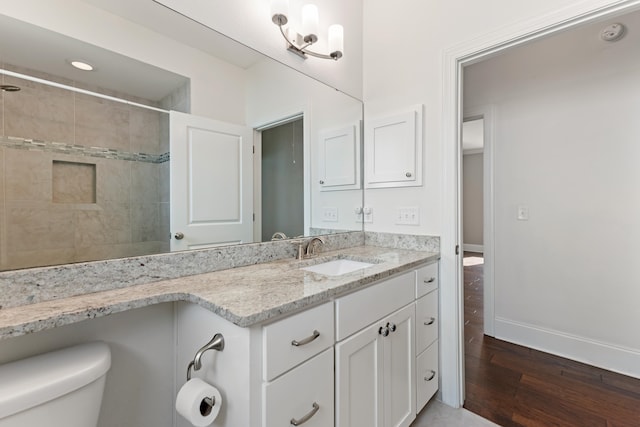 bathroom featuring vanity, baseboards, toilet, and wood finished floors