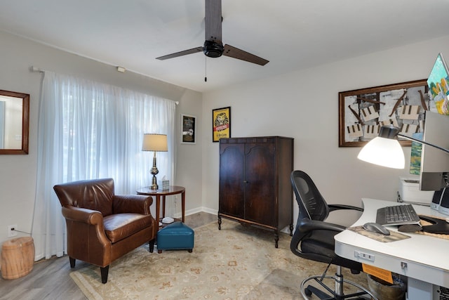 office area featuring a ceiling fan and wood finished floors