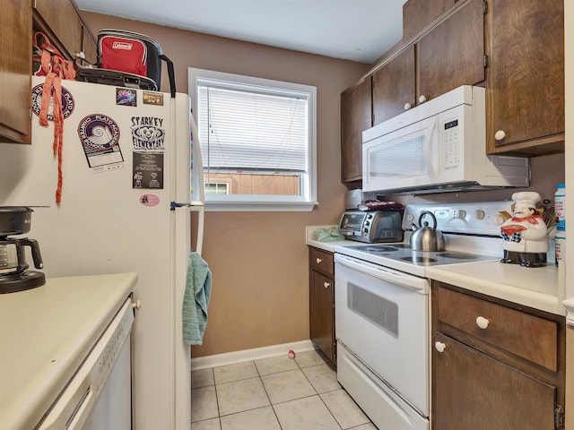 kitchen featuring light tile patterned floors and white appliances