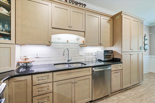 7277 White Clover Ct, Tallahassee, FL 32311 - kitchen with dishwasher, a sink, dark stone countertops, ornamental molding, and glass insert cabinets