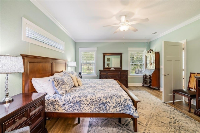 7277 White Clover Ct, Tallahassee, FL 32311 - bedroom featuring multiple windows, light wood-type flooring, ornamental molding, a ceiling fan, and baseboards