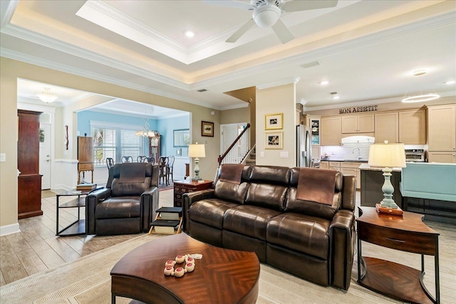 7277 White Clover Ct, Tallahassee, FL 32311 - living room featuring crown molding, stairway, light wood-type flooring, ceiling fan, and a tray ceiling