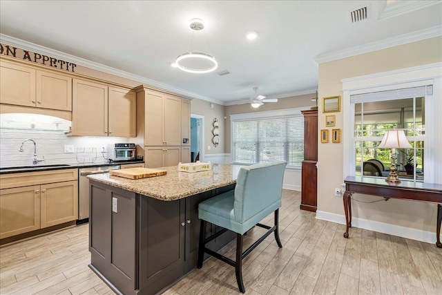 7277 White Clover Ct, Tallahassee, FL 32311 - kitchen featuring a sink, dishwasher, a kitchen bar, light wood-style floors, and a kitchen island