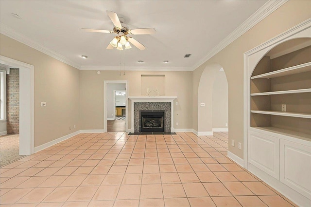 370 Rob Roy Trl, Tallahassee, FL 32312 - unfurnished living room featuring built in shelves, ceiling fan, baseboards, crown molding, and a tile fireplace