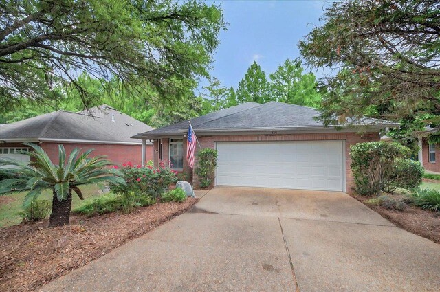 370 Rob Roy Trl, Tallahassee, FL 32312 - ranch-style house with concrete driveway, an attached garage, and brick siding