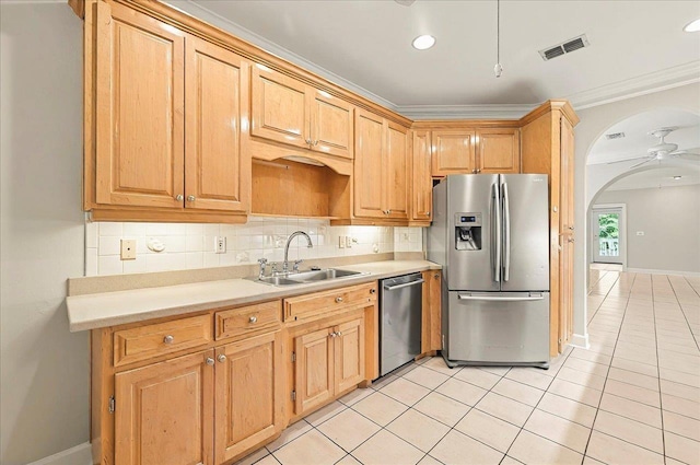 370 Rob Roy Trl, Tallahassee, FL 32312 - kitchen with stainless steel appliances, a sink, crown molding, light countertops, and backsplash