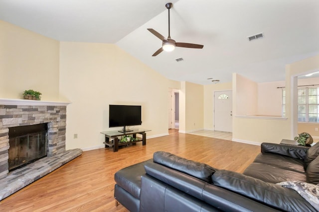 8325 Yellow Ln, Tallahassee, FL 32311 - living room featuring a ceiling fan, light wood-type flooring, a stone fireplace, and lofted ceiling